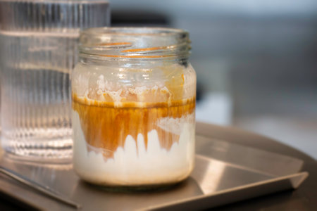 Glass of espresso shot mixed with cold fresh milk, stock photoの写真素材