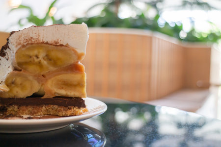 Banoffee cake with bananas and whipped cream in cafe restaurant, stock photoの写真素材