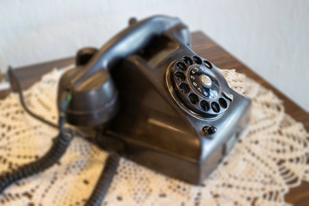 Beautiful old black telephone on a wooden table, stock photoの写真素材