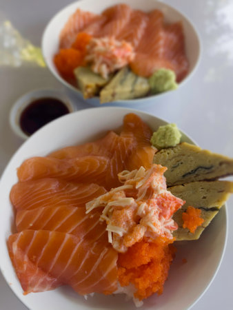 Salmon topped rice served with wasabi and soy sauce, stock photoの写真素材