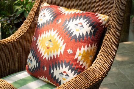 Colorful pillow on rattan chair, Thailand. Selective focus.
