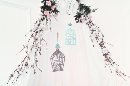 Wonderful branch with blossoming flowers with birds and bird cageの写真素材