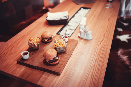 fast food set big hamburger and french fries with wine. shallow DOFの写真素材
