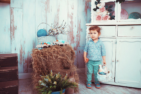 The little red-haired girl playing in the room with the spring interior. The concept of happiness,...