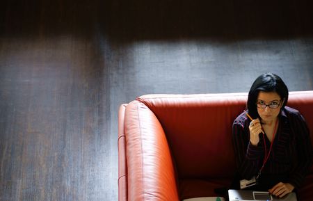 Young Business Woman on Sofa Looking Up