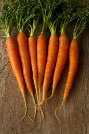delicious organic carrots on a brown backgroundの写真素材