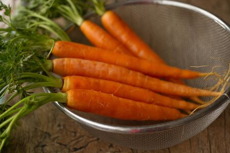delicious organic carrots on a brown backgroundの写真素材