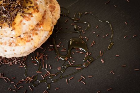 pancakes with honey and maple syrup with chocolate sprinklesの写真素材