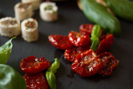 crackers with goat cheese, sun-dried tomatoes and basilの写真素材