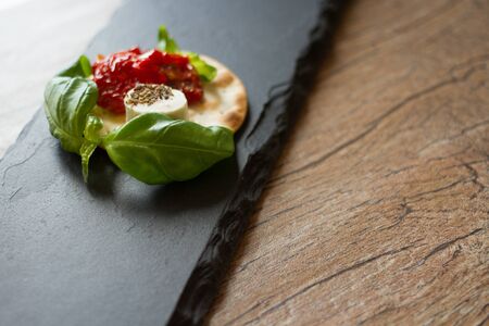 crackers with goat cheese, sun-dried tomatoes and basilの写真素材