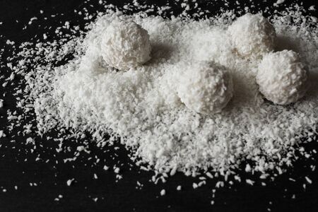 coconut and Raffaello on a black backgroundの写真素材