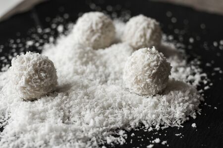 coconut and Raffaello on a black backgroundの写真素材