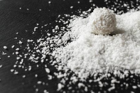 coconut and Raffaello on a black backgroundの写真素材