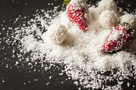 Raffaello coconut and strawberry on a black backgroundの写真素材