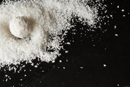 coconut and Raffaello on a black backgroundの写真素材