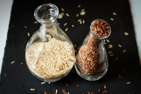 white and brown rice in vases. dietary productの写真素材