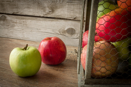 multicolored apples in a gray vintage birdcagesの写真素材
