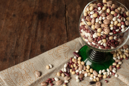 beans and peas in a green glass standing on linen