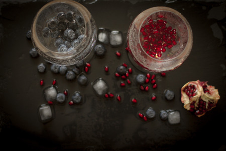 drink with blueberries and pomegranate groceries on wood backgroundの写真素材