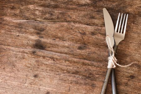 old fork and knife tied with a ropeの写真素材