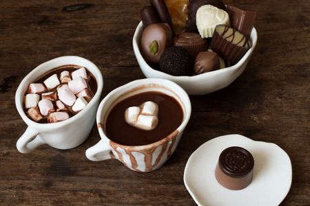 Belgian chocolate in a white bowl on a wooden table