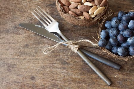 blueberries and almonds in the shell of a coconutの写真素材