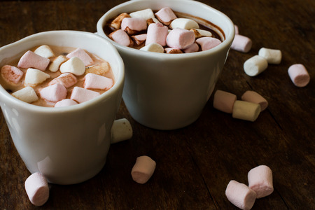 Belgian chocolate in a white bowl on a wooden tableの写真素材
