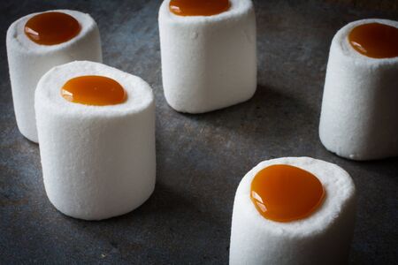white marshmallows with caramel on wood backgroundの写真素材