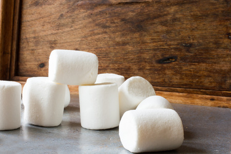 white marshmallow pieces on wood backgroundの写真素材
