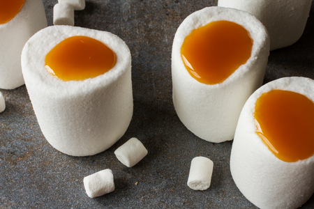 white marshmallows with caramel on wood backgroundの写真素材