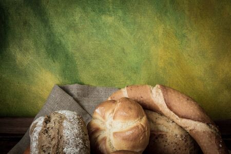 various rolls of wheat breads on wooden tableの写真素材