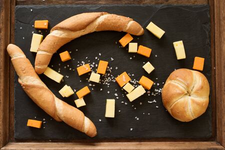 yellow and white cheddar cheese on a black backgroundの写真素材