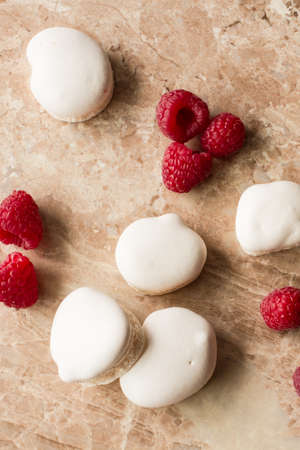 white marshmallows with ripe red raspberriesの写真素材