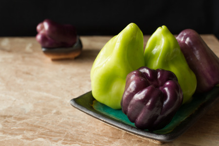 purple and green peppers on a marble backgroundの写真素材