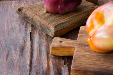 pepper on old wooden cutting board on a wooden backgroundの写真素材