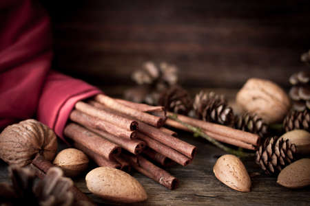 Christmas mood. cinnamon, walnuts and pine coneの写真素材