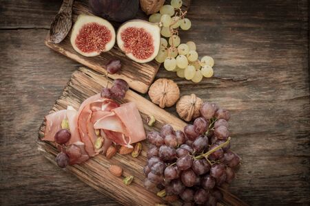 snacks for wine grapes in the form of dates and bacon,の写真素材