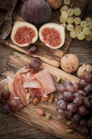 snacks for wine grapes in the form of dates and bacon,の写真素材