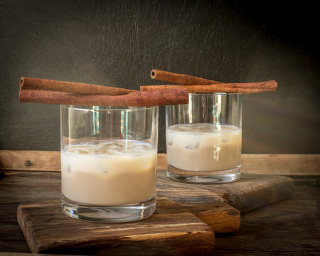 Irish cream liqueur in a glass with ice and cinnamon