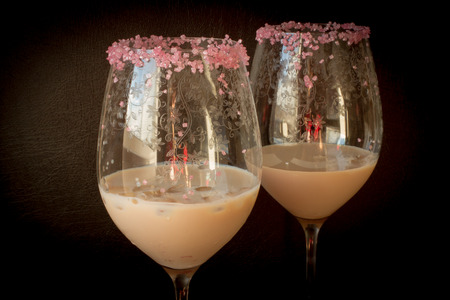 Irish cream liqueur in a glass with ice with a pink sugarの写真素材