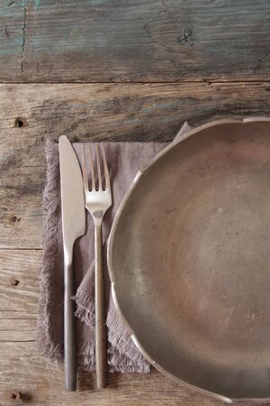 old metal dish with fork and knifeの写真素材