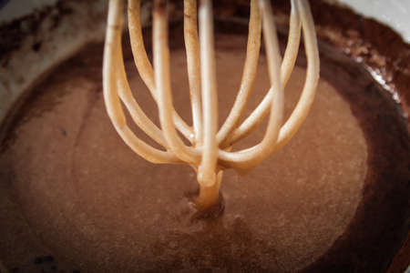 whisk with sugar and cocoa. the ingredients for the cakeの写真素材