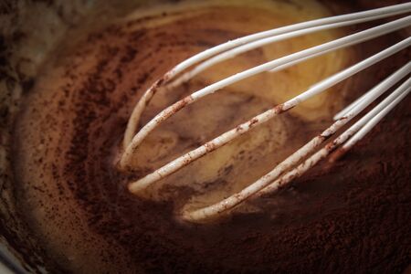 whisk with sugar and cocoa. the ingredients for the cakeの写真素材