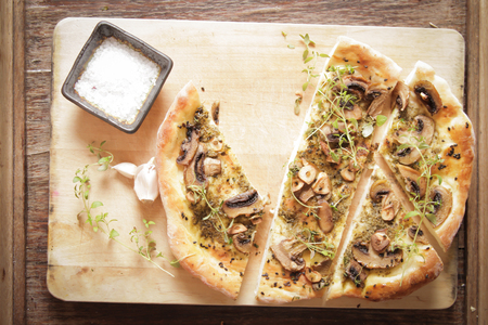 homemade Italian pizza with mushrooms and pestoの写真素材