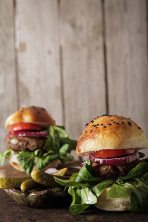 homemade veggie burger in a bun with sesame seeds of beer. delicious fast food for vegans. on a wooden backgroundの写真素材