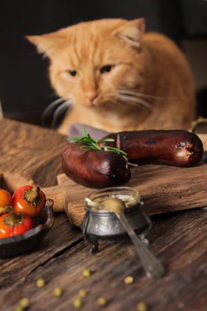 bratwurst grill with salt and pepper and rosemary on brown wooden backgroundの写真素材