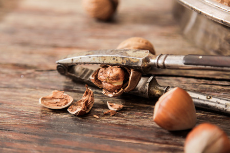 mixture of nuts on a metal plate with orehokolom on a wooden backgroundの写真素材