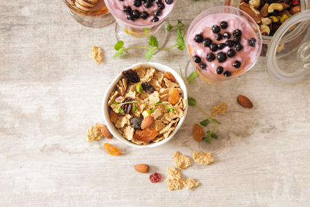 cup of blueberry yogurt with granola and honey light breakfast
