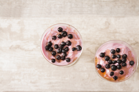 cup of blueberry yogurt with granola and honey light breakfastの写真素材