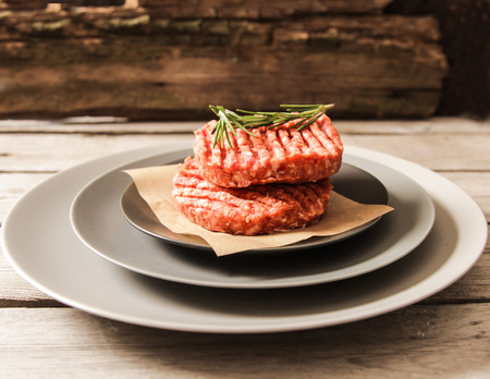 Raw Ground beef meat Burger steak cutlets on  wooden backgroundの写真素材